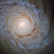 This image shows the galaxy Messier 94, which lies in the small northern constellation of the Hunting Dogs, about 16 million light-years away. Within the bright ring around Messier 94 new stars are forming at a high rate and many young, bright stars are present within it – thanks to this, this feature is called a starburst ring. The cause of this peculiarly shaped star-forming region is likely a pressure wave going outwards from the galactic centre, compressing the gas and dust in the outer region. The compression of material means the gas starts to collapse into denser clouds. Inside these dense clouds, gravity pulls the gas and dust together until temperature and pressure are high enough for stars to be born.