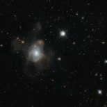 This curious galaxy — only known by the seemingly random jumble of letters and numbers 2MASX J16270254+4328340 — has been captured by the NASA/ESA Hubble Space Telescope dancing the crazed dance of a galactic merger. The galaxy has merged with another galaxy leaving a fine mist, made of millions of stars, spewing from it in long trails. Despite the apparent chaos, this snapshot of the gravitational tango was captured towards the event’s conclusion. This transforming galaxy is heading into old age with its star-forming days coming to an end. The true drama occurred earlier in the process, when the various clouds of gas within the two galaxies were so disturbed by the event that they collapsed, triggering an eruption of star formation. This flurry of activity exhausted the vast majority of the galactic gas, leaving the galaxy sterile and unable to produce new stars. As the violence continues to subside, the newly formed galaxy’s population of stars will redden with age and eventually begin drop off one by one. With no future generations of stars to take their place, the galaxy thus begins a steady descent towards death.
