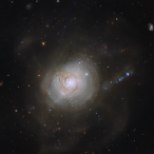 Only rarely does an astronomical object have a political association. However, the spiral galaxy NGC 7252 acquired exactly that when it was given an unusual nickname. In December 1953, the US President Dwight D. Eisenhower gave a speech advocating the use of nuclear power for peaceful purposes. This  “Atoms for Peace” speech was significant for the scientific community, as it brought nuclear research into the public domain, and NGC 7252, which has a superficial resemblance to an atomic nucleus surrounded by the loops of electronic orbits, was dubbed the Atoms for Peace galaxy in honour of this. These loops are well visible in a wider field of view image. This nickname is quite ironic, as the galaxy’s past was anything but peaceful. Its peculiar appearance is the result of a collision between two galaxies that took place about a billion years ago, which ripped both galaxies apart. The loop-like outer structures, likely made up of dust and stars flung outwards by the crash, but recalling orbiting electrons in an atom, are partly responsible for the galaxy’s nickname. This NASA/ESA Hubble Space Telescope image shows the inner parts of the galaxy, revealing a pinwheel-shaped disc that is rotating in a direction opposite to the rest of the galaxy. This disc resembles a spiral galaxy like our own galaxy, the Milky Way, but is only about 10 000 light-years across — about a tenth of the size of the Milky Way. It is believed that this whirling structure is a remnant of the galactic collision. It will most likely have vanished in a few billion years’ time, when NGC 7252 will have completed its merging process.